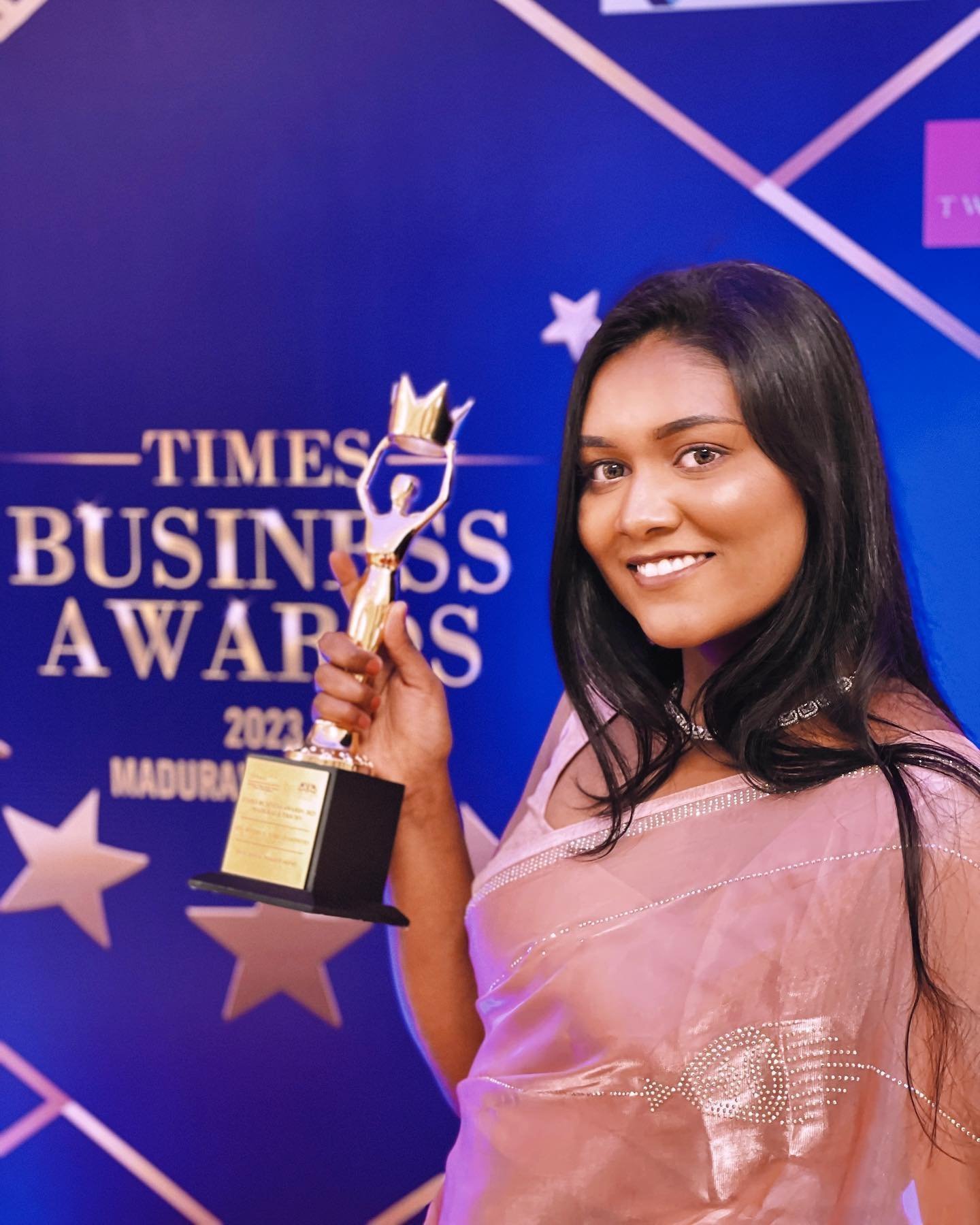 Anu Rotrico holding her Times Business Awards 2023 trophy