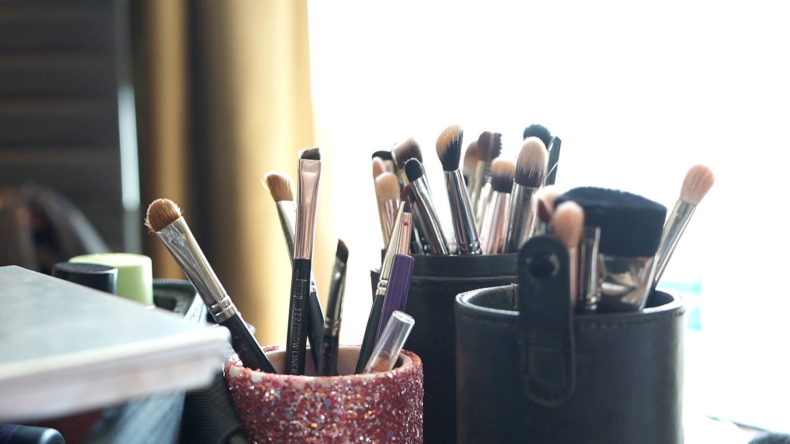 Anu Rotrico's professional makeup brushes and kit by the window light