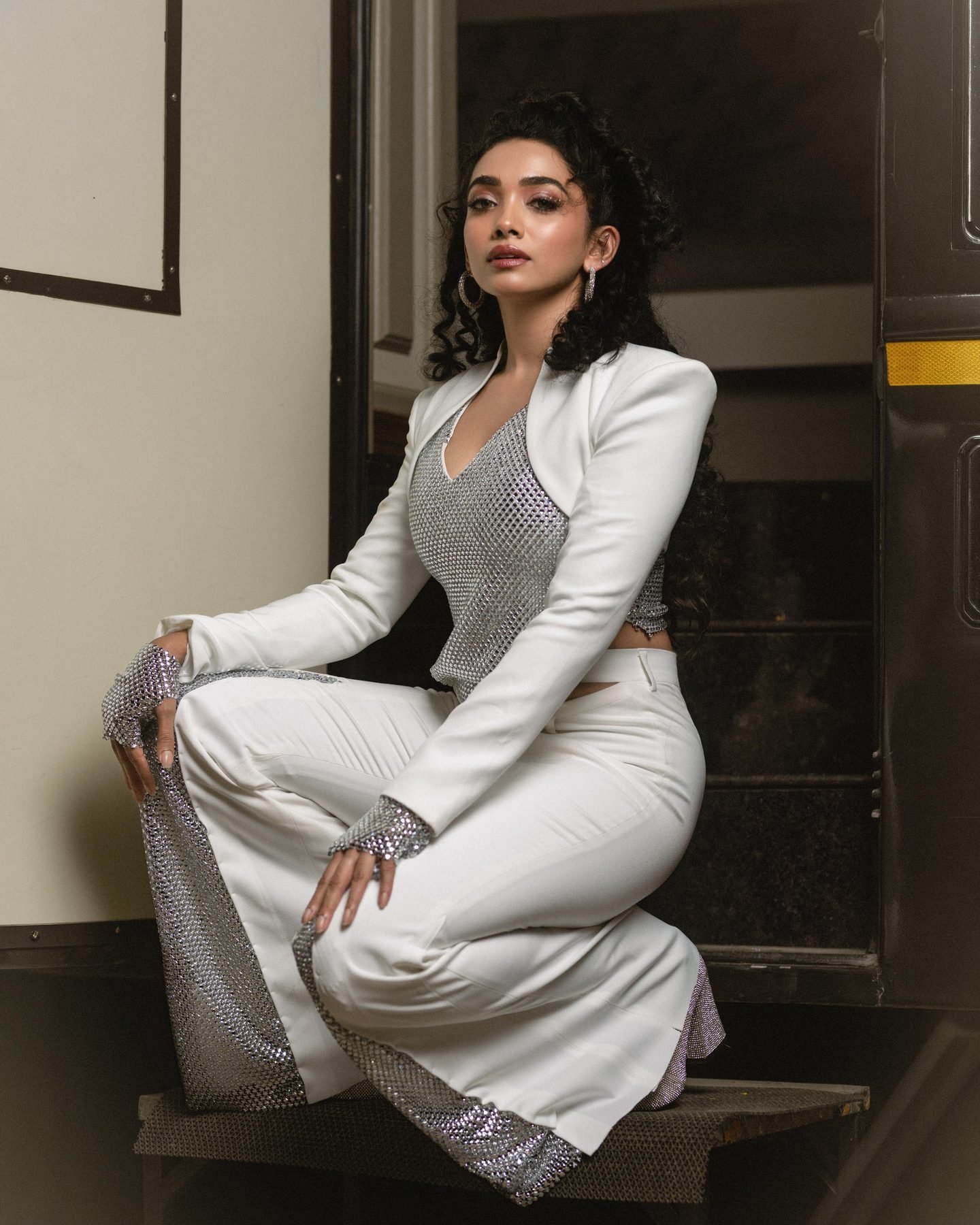 Saanve Megghana seated backstage in her white and silver stage costume