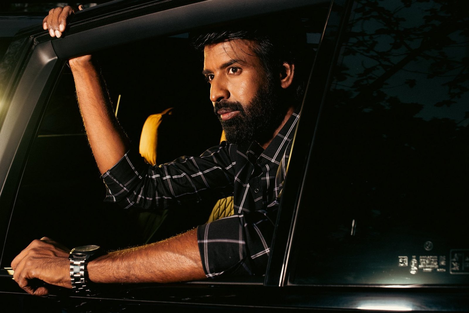Actor Soori leaning from the car window during the Provoke Lifestyle night shoot