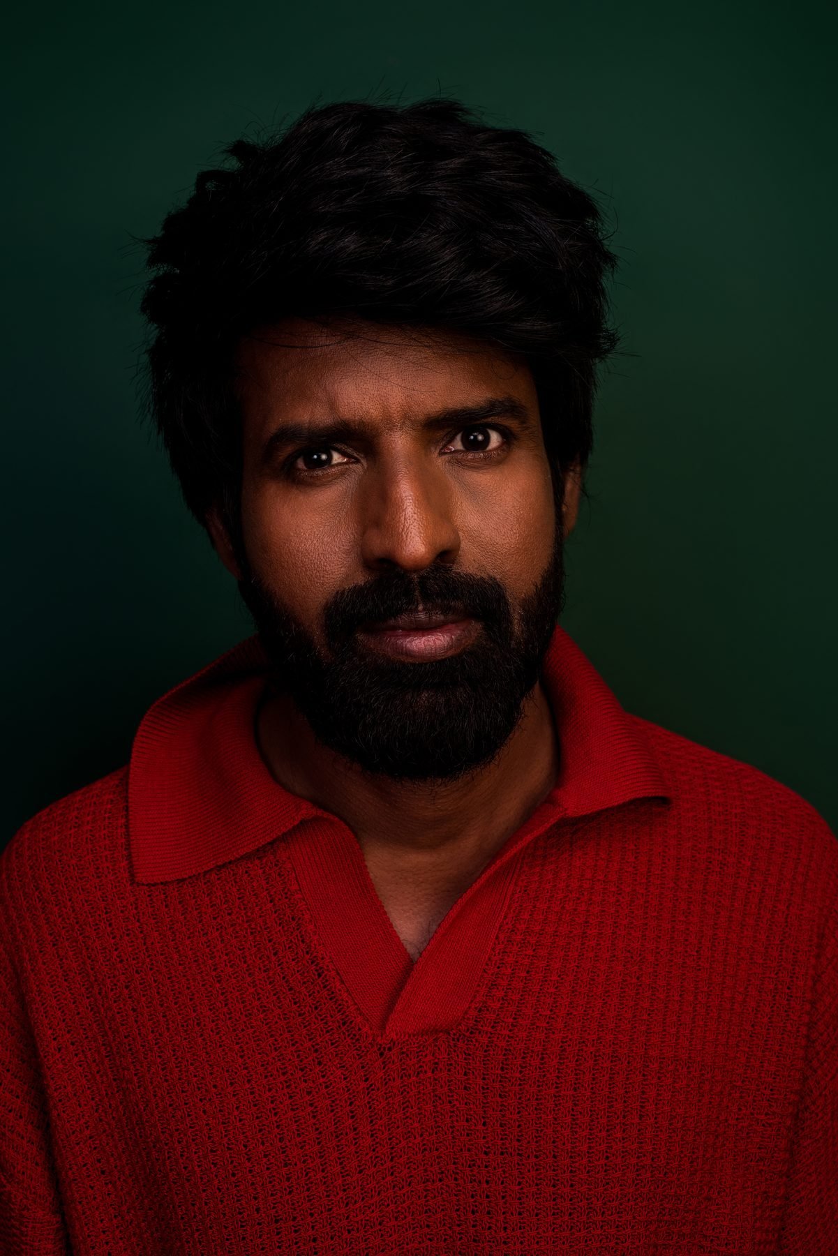 Portrait of actor Soori in red, makeup by Anu Rotrico